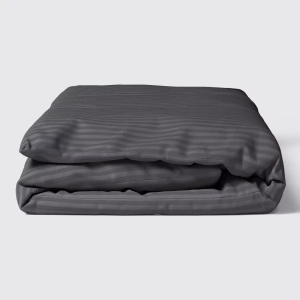 neatly folded charcoal grey duvet