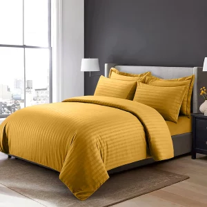 saffron duvet cover and pillowcases arranged on a bed
